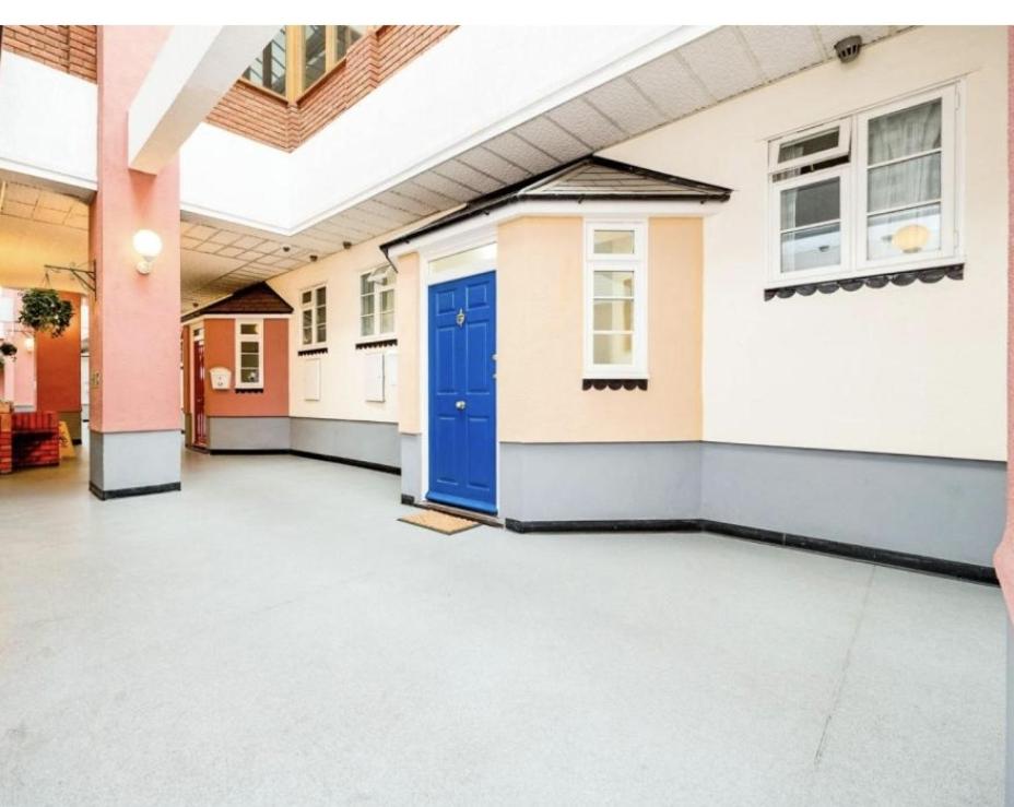an empty room with a blue door in a building at Queensgate centre in Stifford