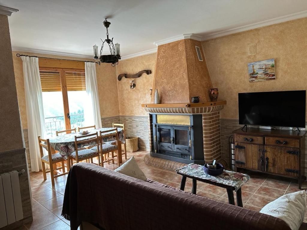 a living room with a couch and a fireplace at Casas Rurales Cerro Lobo in Yeste