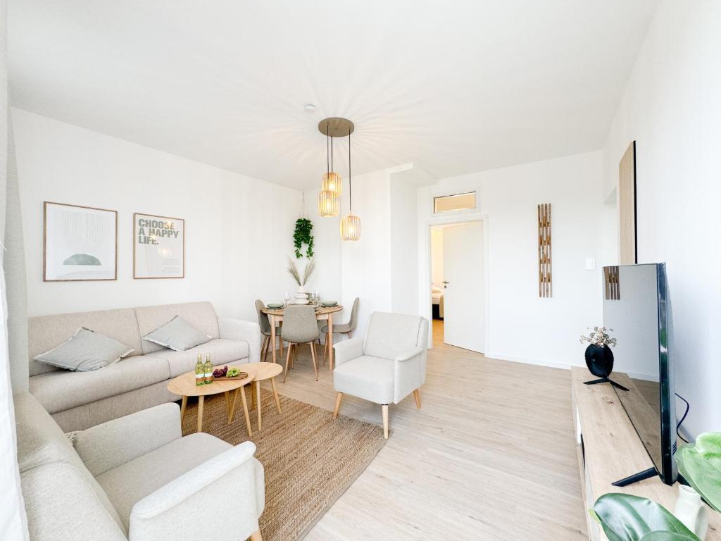 a living room with a couch and a table at Lifestyle Penthouse Apartment in Ludwigshafen am Rhein