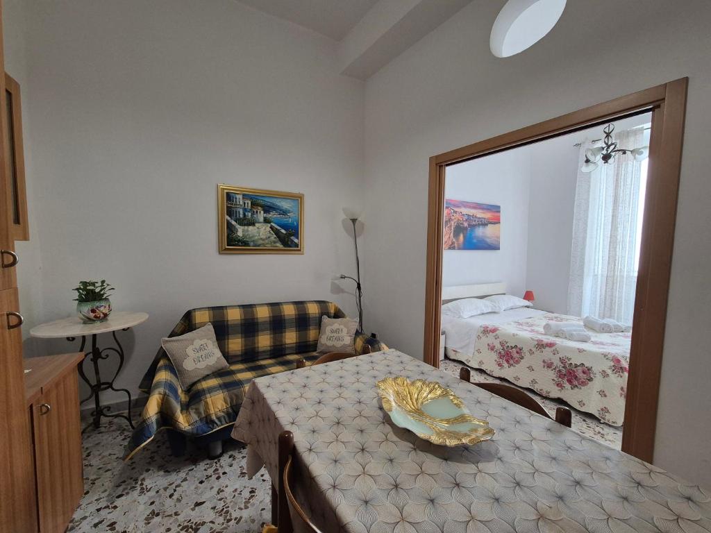 a room with a bedroom with a bed and a chair at Casa Aurora in Polignano a Mare