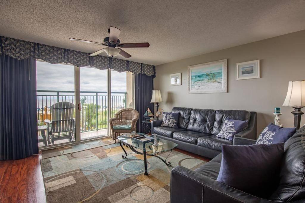 a living room with a couch and a balcony at Windy Hill Dunes 104 condo in Myrtle Beach