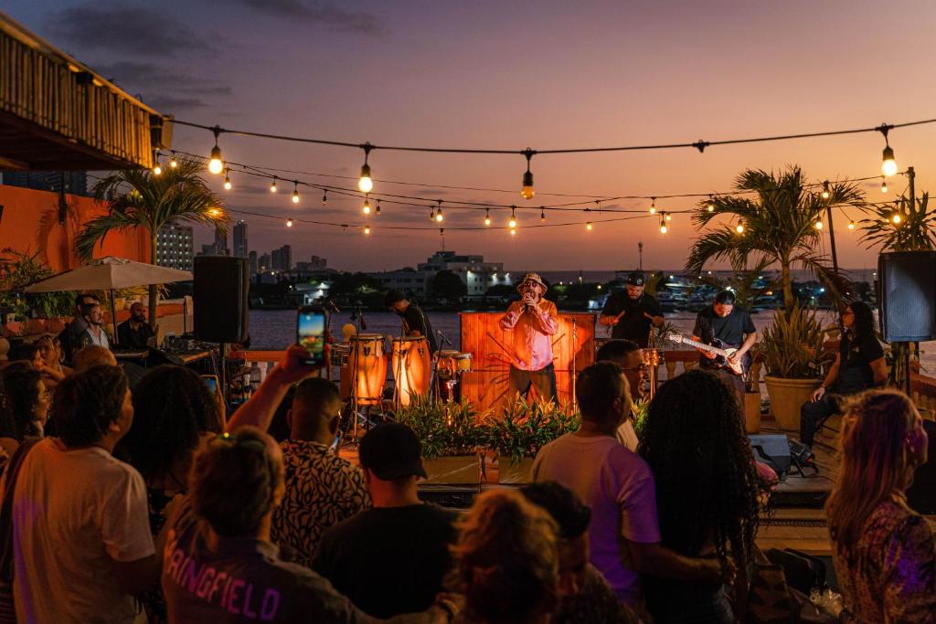 a crowd of people watching a man on a stage at Selina Cartagena in Cartagena de Indias