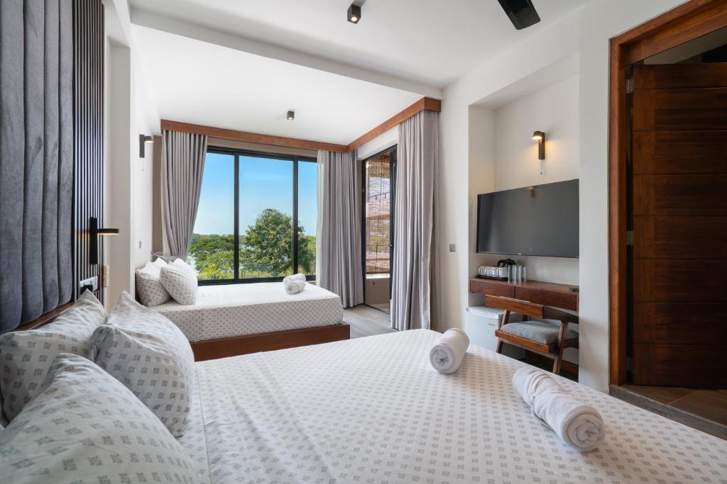 Postel nebo postele na pokoji v ubytování Thimbiri Wewa Resort Wilpattu