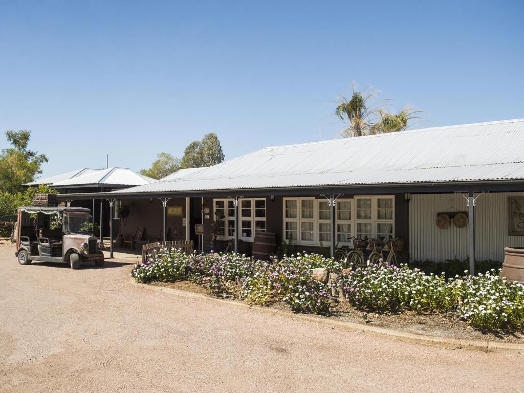 a building with a car parked in front of it at Saltbush Retreat in Longreach