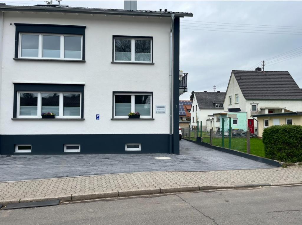 a white house with two windows and a driveway at Pension zum Ahrblick in Sinzig