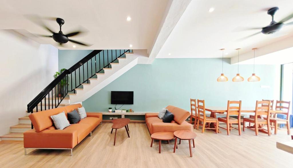 a living room with a couch and chairs and a table at 35 BeachHouse Batu Ferringhi 7 Bedroom 7 Bathroom EV friendly in Batu Ferringhi