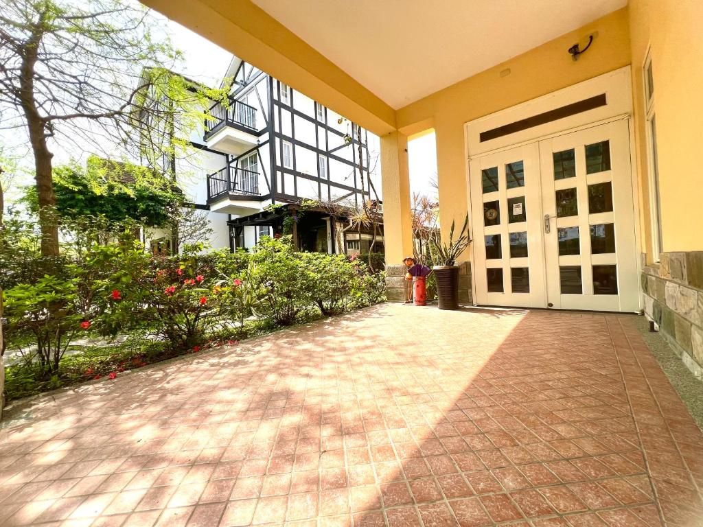 a front door of a building with a brick driveway at Annongriver B&amp;B in Sanxing