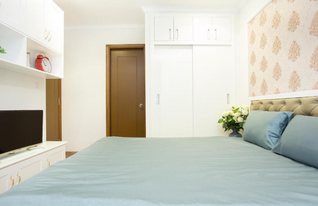 Postel nebo postele na pokoji v ubytování Saigon Downtown - Rivergate Residence