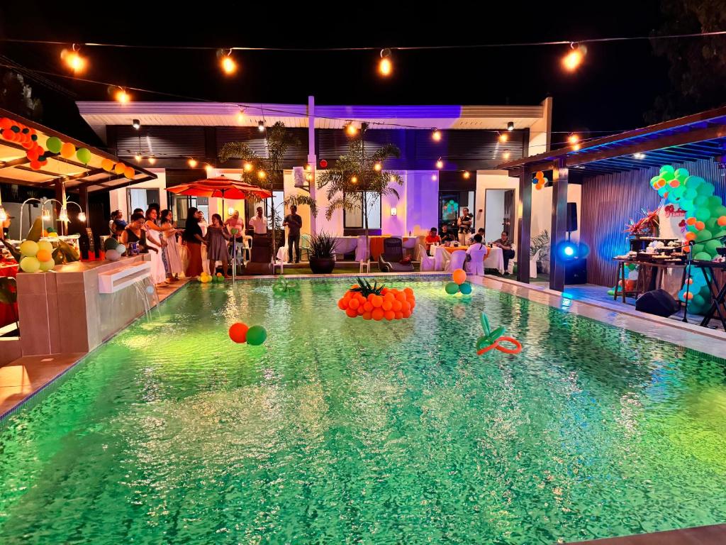 a pool with balls in the water at a party at Dano Private Resort and Apartments in Dauis