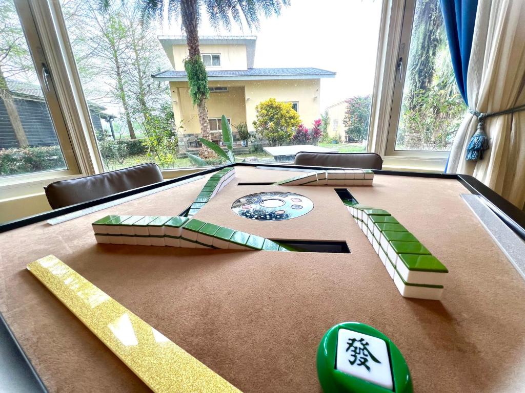 a ping pong table in a room with windows at Annongriver B&amp;B in Sanxing