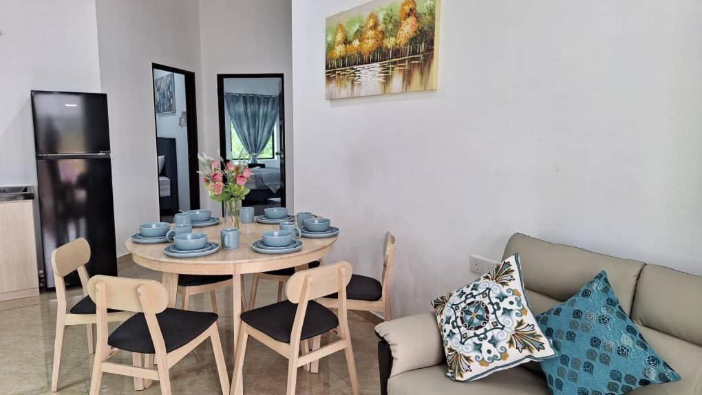 a living room with a table and a couch at Ocean Cottage 2, Radiant Teluk Sari in Kampung Mawar