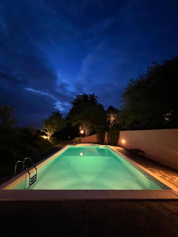 an empty swimming pool at night at Podere Montemarchi in Lari