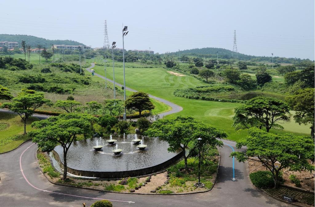 an aerial view of a fountain in a park at ArdenHill Resort & Golf in Jeju