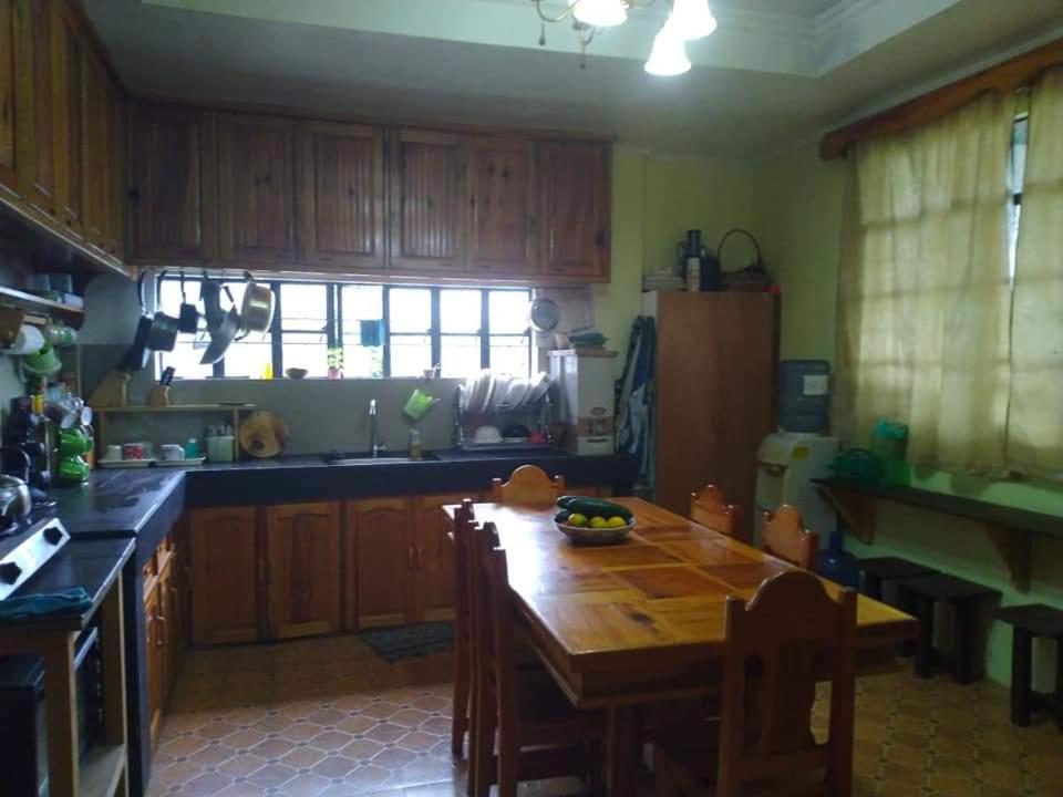 a kitchen with a wooden table and a tableasteryasteryasteryasteryasteryasteryastery at Mavy's Maligcong Homestay in Bontoc