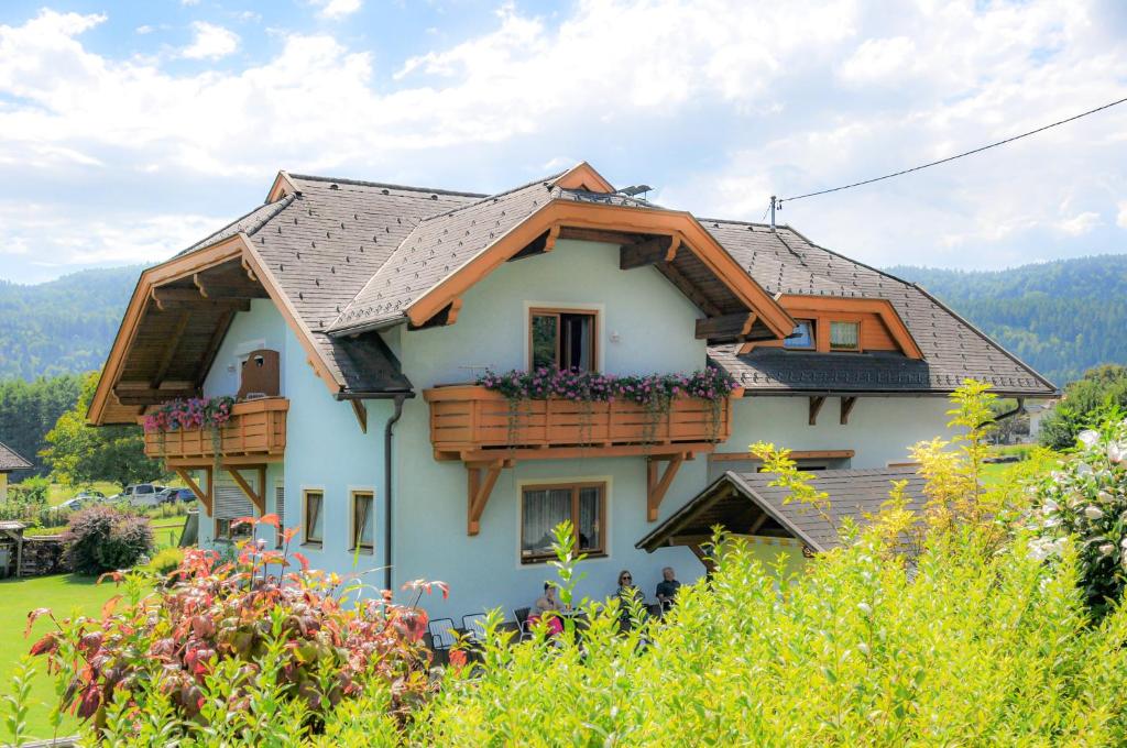 a house with two balconies on the side of it at Ferienwohnungen am See Haus Spitzer in Keutschach am See