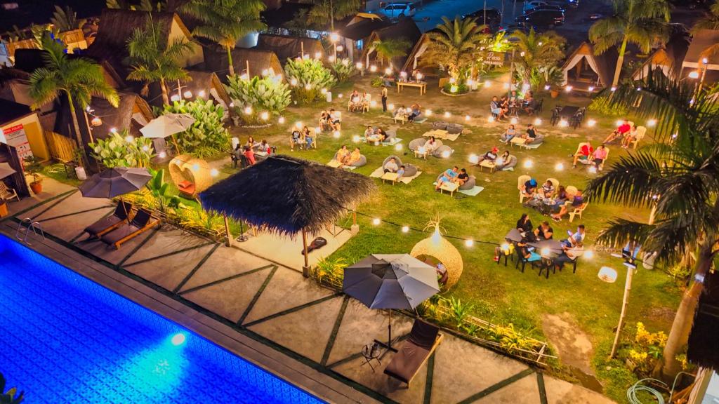 an overhead view of a pool at a resort at night at Reca Resort Official in Porac