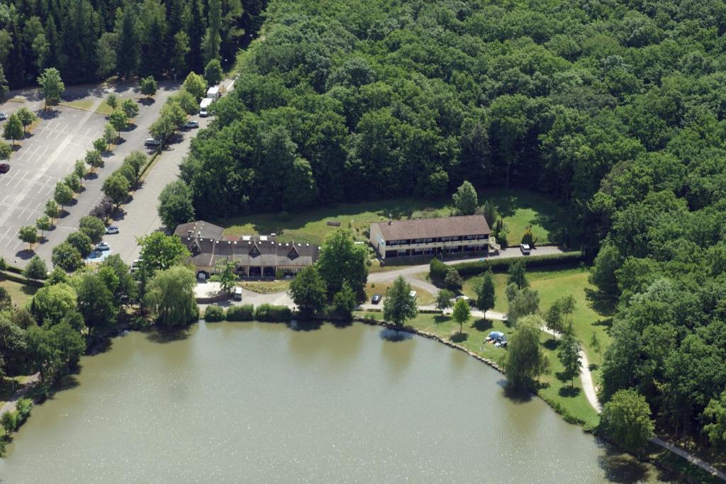 an aerial view of a building next to a lake at Hotel Restaurant des Lacs in Contrexéville