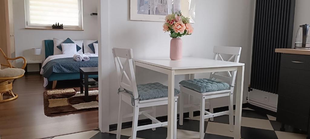 um quarto com uma mesa e duas cadeiras e uma cama em Apartament na Poli em Wałbrzych