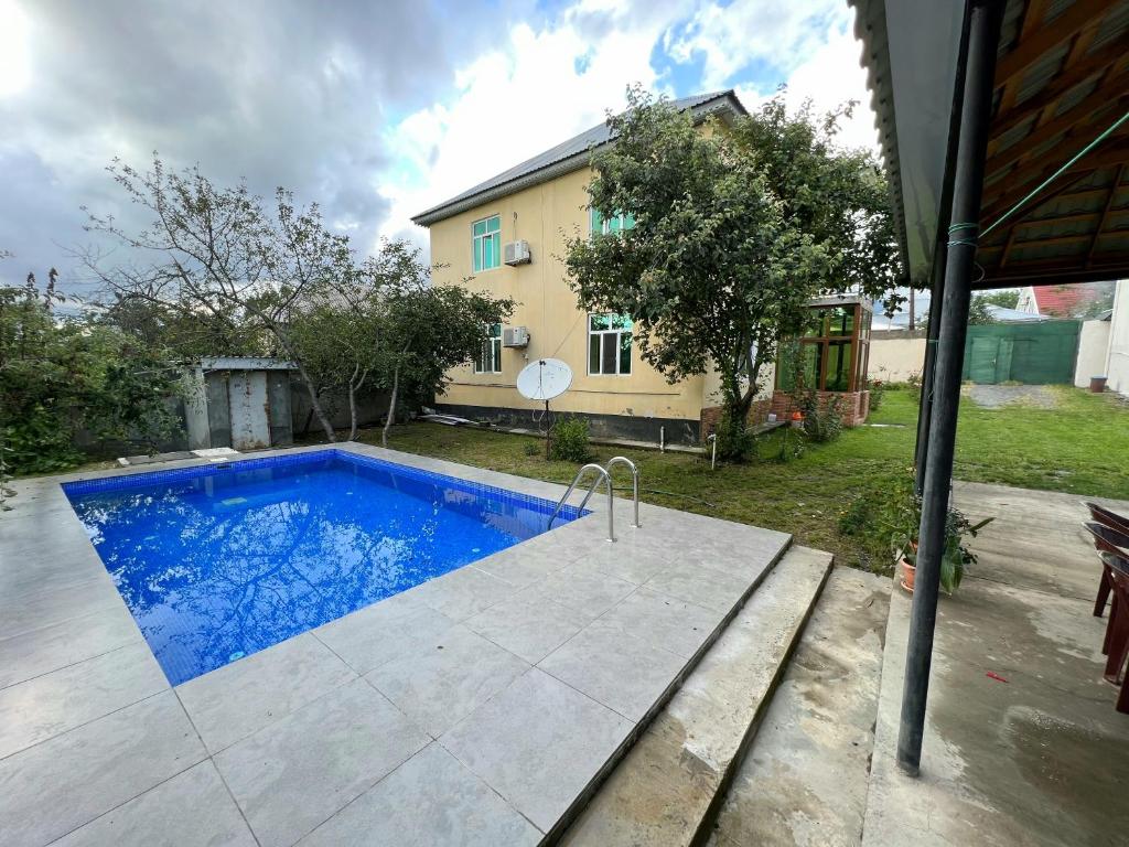 a swimming pool in the backyard of a house at Villa at the center in Gabala