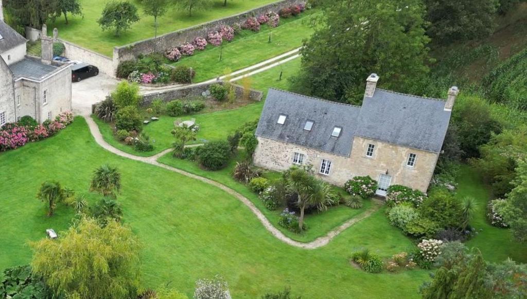 an aerial view of a large house with a yard at Gites Du Manoir de Savigny in Valognes