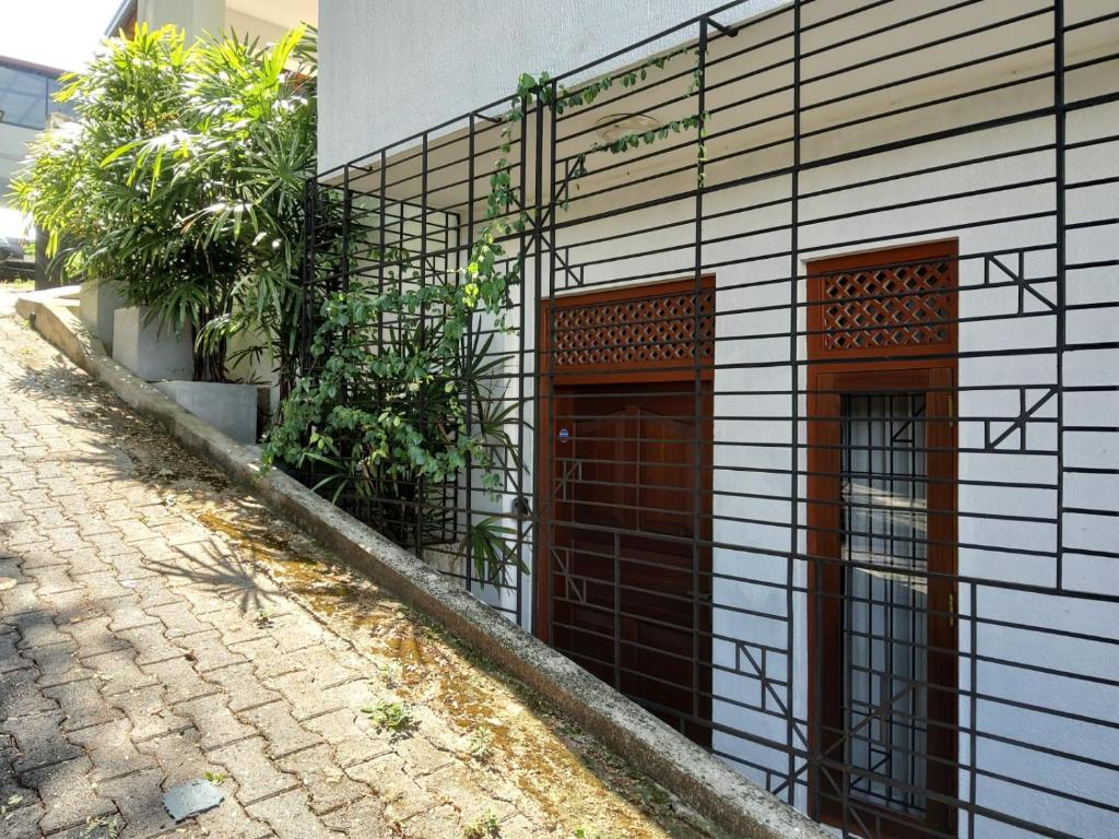 two doors on the side of a building at Comfortable and serene cottage surrounded with palms and tamarind tree in Rajagiriya