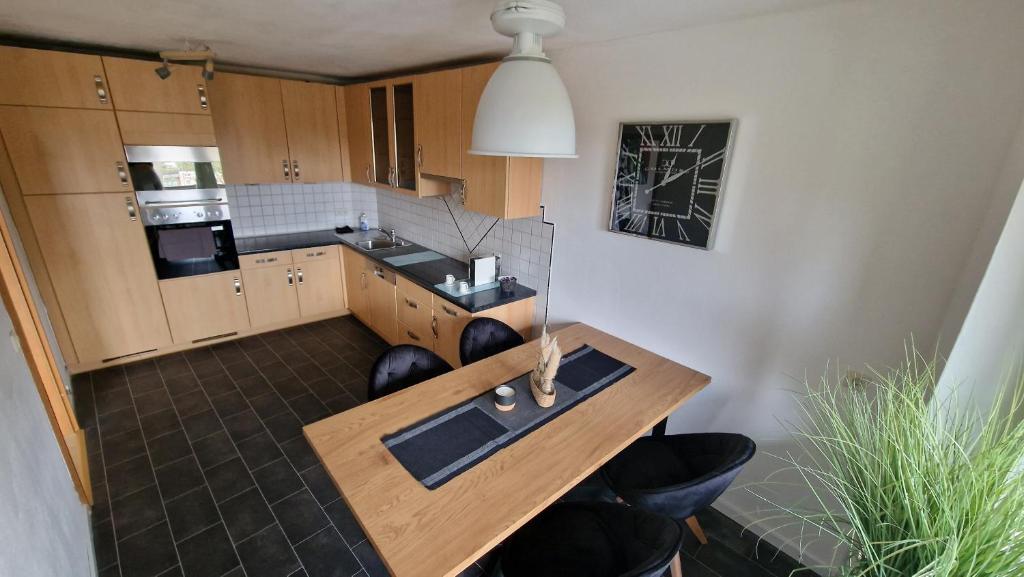 a kitchen with a wooden table in a room at Ferienwohnung Forchtenberg 3 Zimmer in Forchtenberg