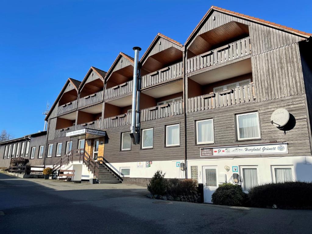 a large building with balconies on the side of it at Harzhotel Grünett in Langelsheim