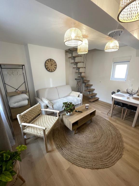 a living room with a couch and a table at Bmco cottage in Estrées-Saint-Denis