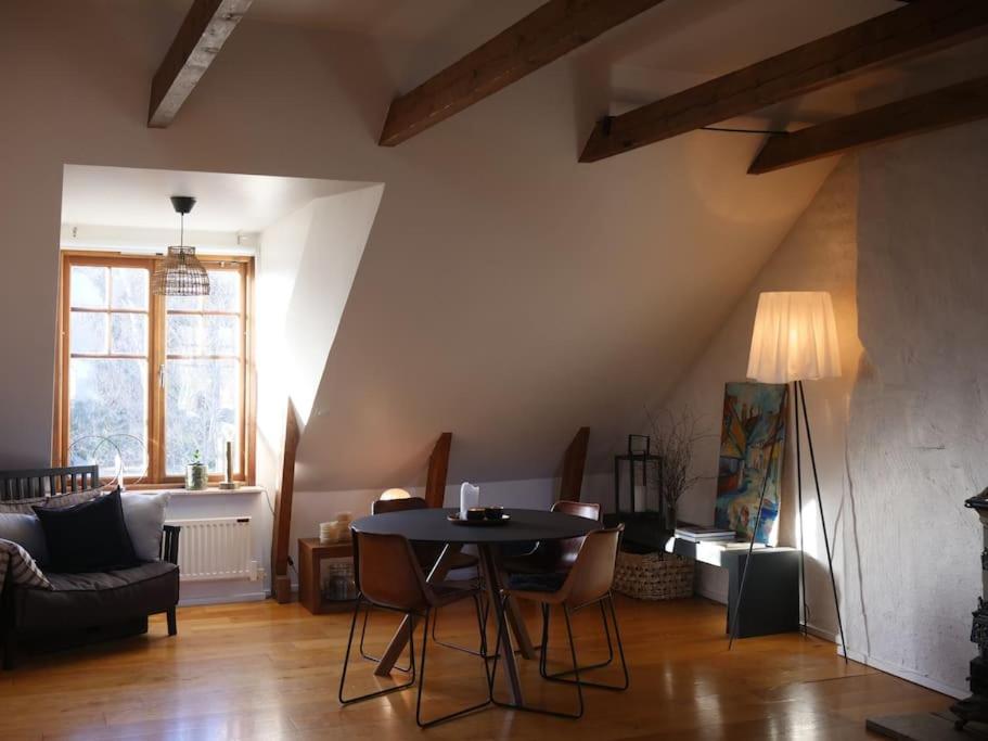a living room with a table and a couch at Spacious Penthouse close to center in Stockholm