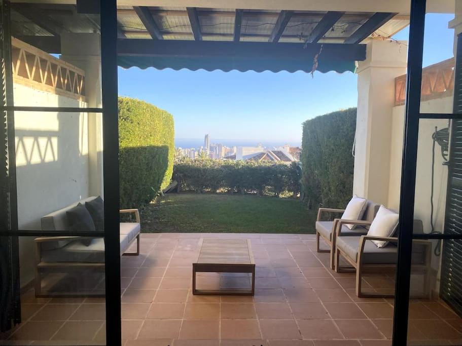 a patio with couches and a table and a view at Bungalow house with views in Finestrat