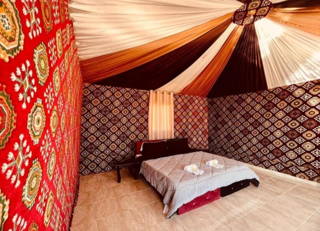 a bedroom with a bed in a tent at Wadi rum sand Delight camp in Wadi Rum