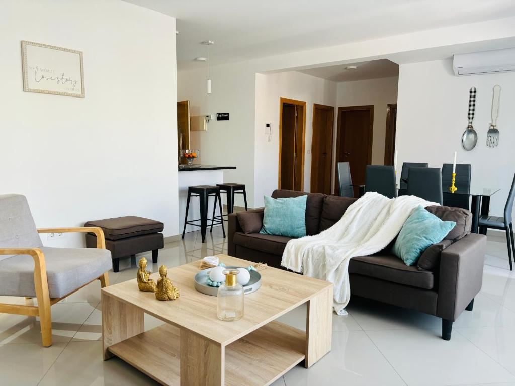 a living room with a couch and a coffee table at Techas Near Beach Apt with Pool in Praia