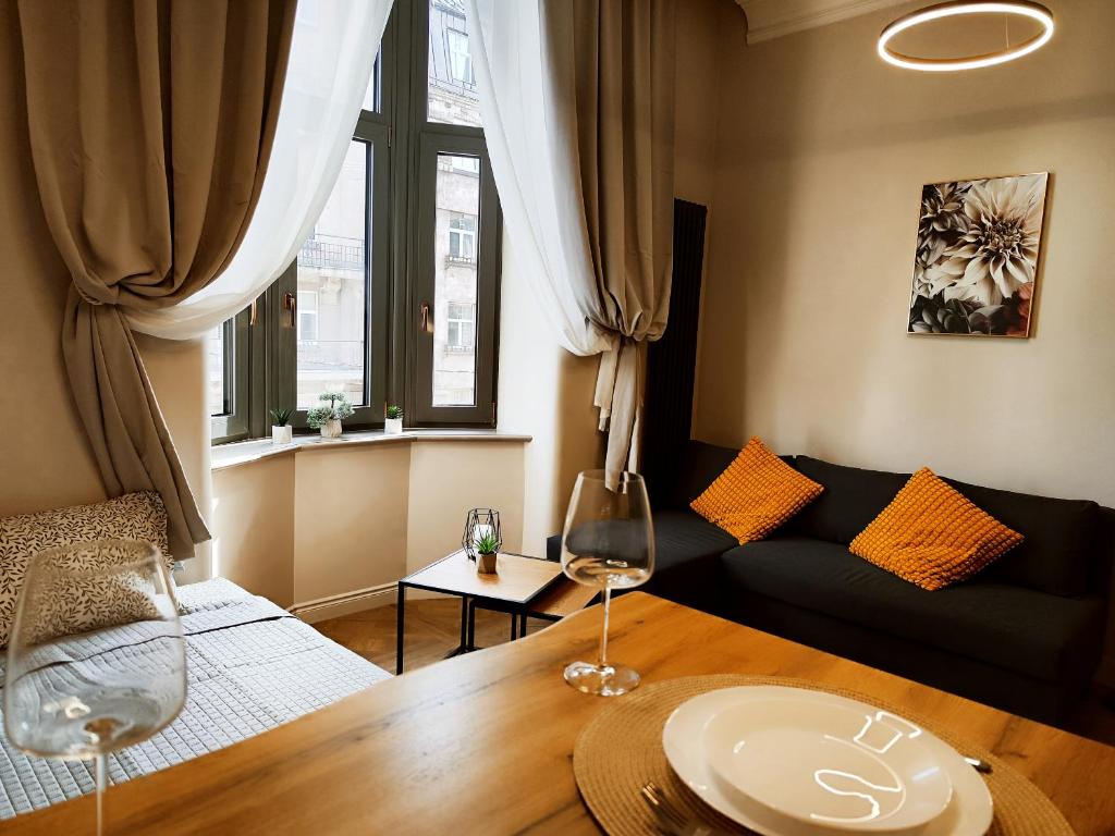 a living room with a table and two wine glasses at New luxury apartment in the center in Rīga
