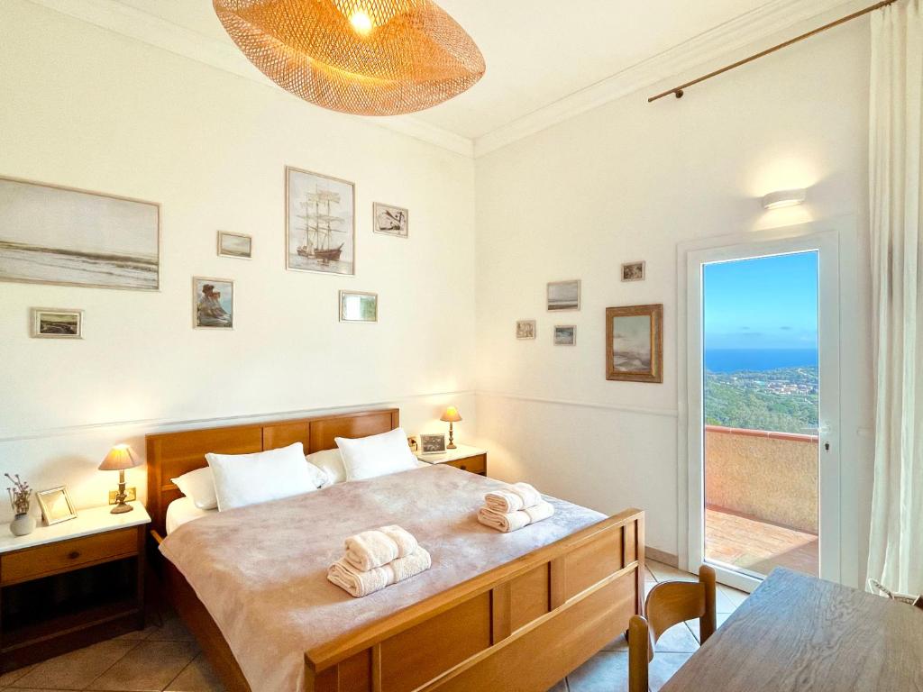 A bed or beds in a room at Aria di Collina - Isola d'Elba