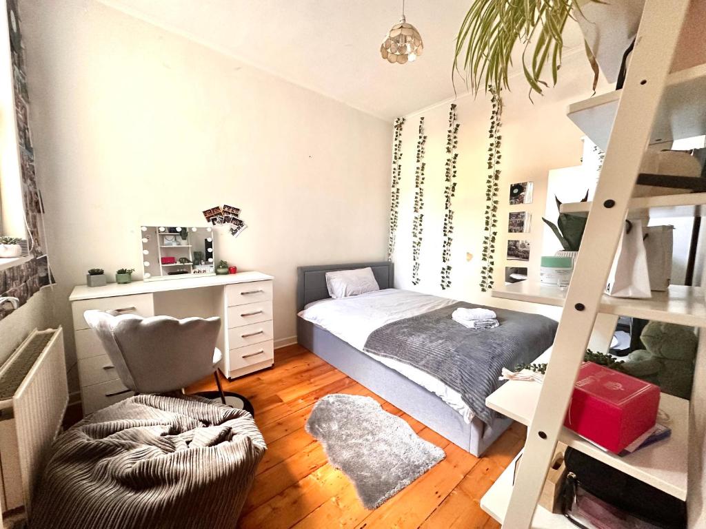 a small bedroom with a bed and a ladder at A lovely guest room in West London in London