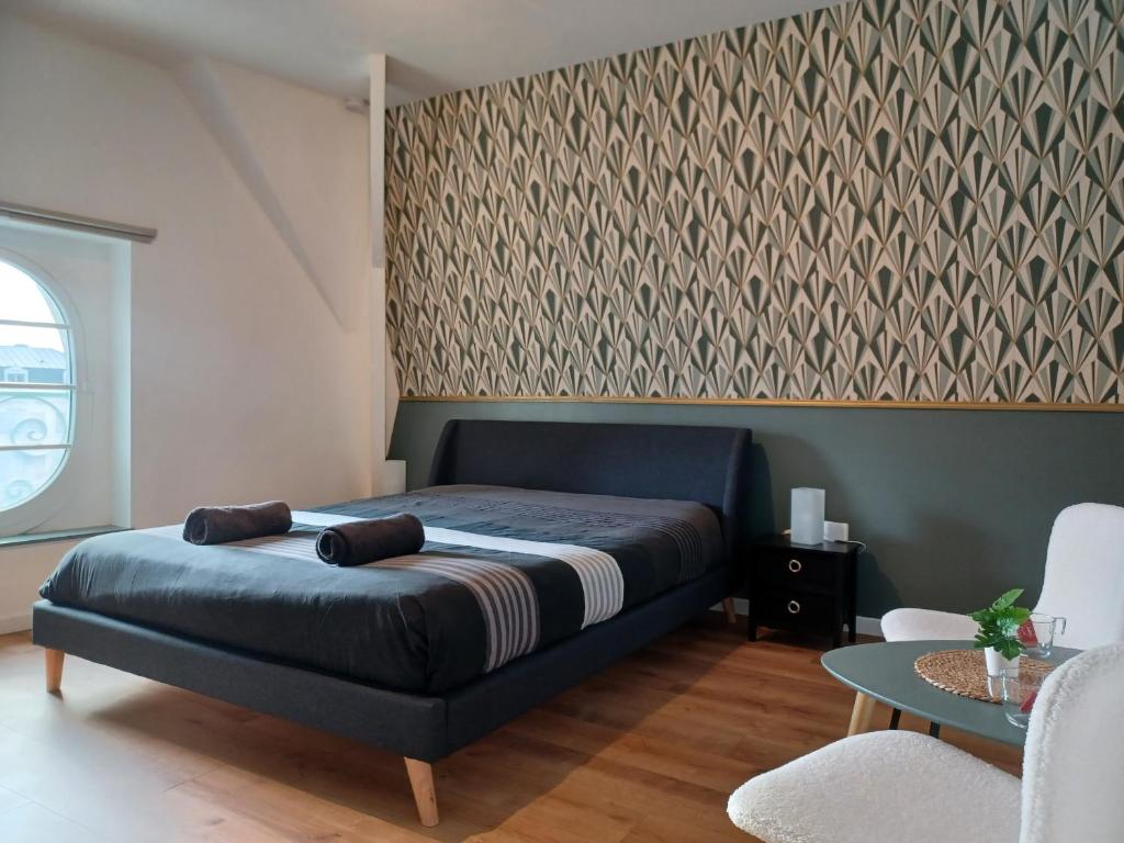Un dormitorio con una cama azul y una pared en "Au pied du Beffroi" - Superbe emplacement, en Arras