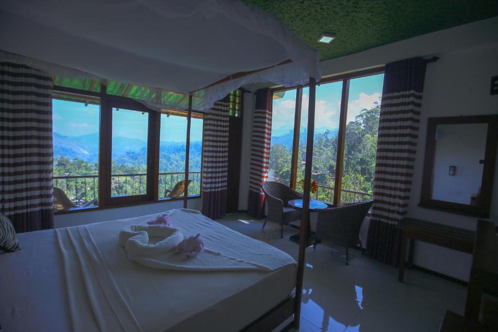 a bedroom with a bed with a view of a mountain at Ella Nine Arch lodge in Ella