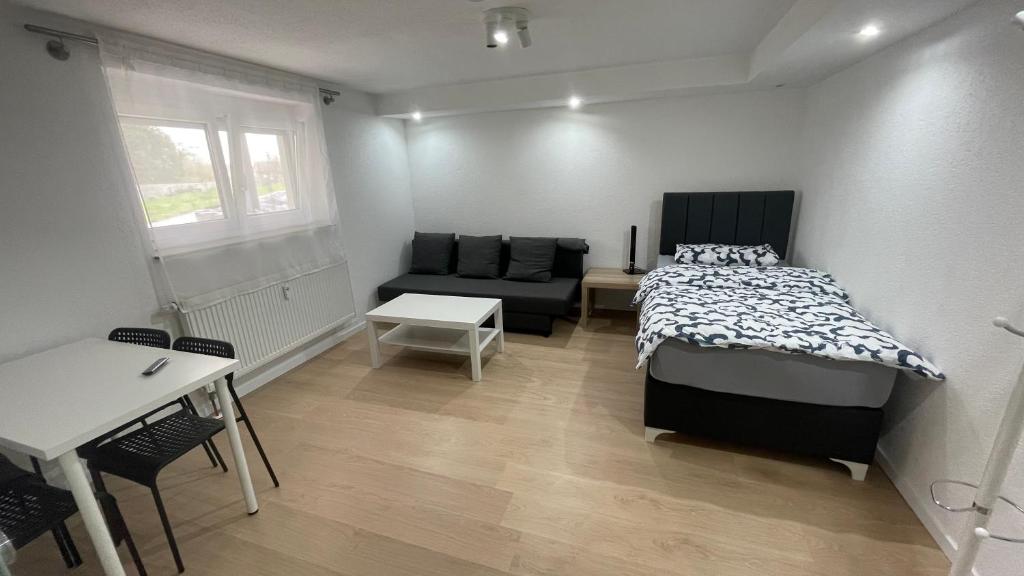 a bedroom with a bed and a couch and a table at Apartment Erbach-Ulm in Erbach