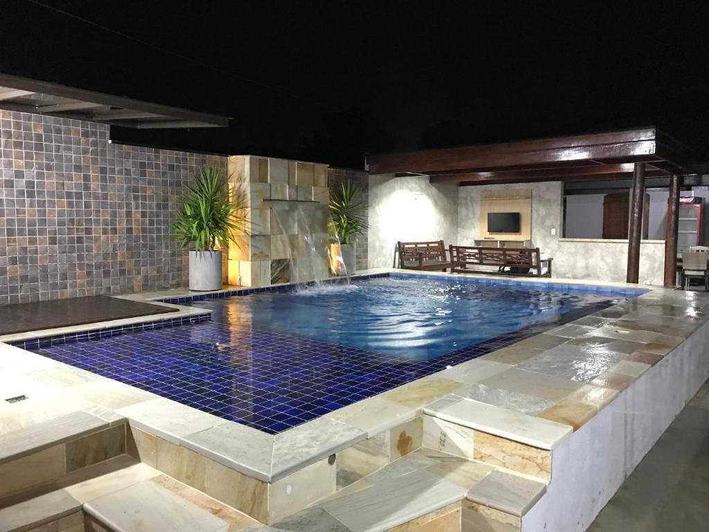 a large swimming pool in a building at Beach House Ocean in Bertioga