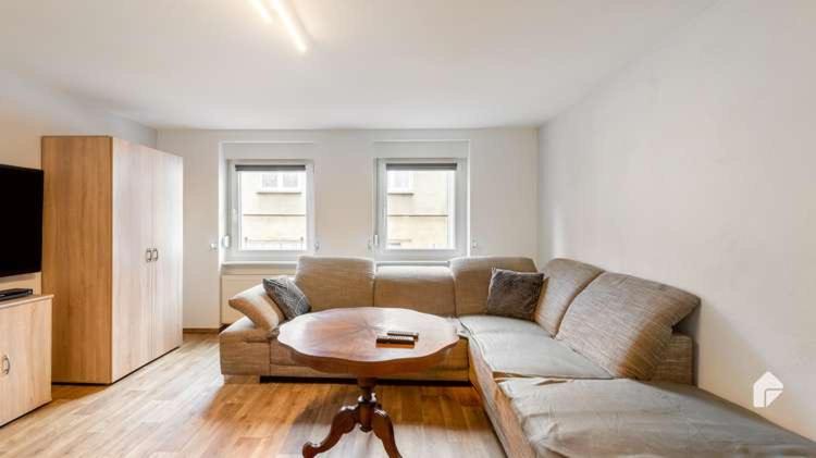 a living room with a couch and a table at Große Ferienwohnung mitten in Bad Belzig in Bad Belzig