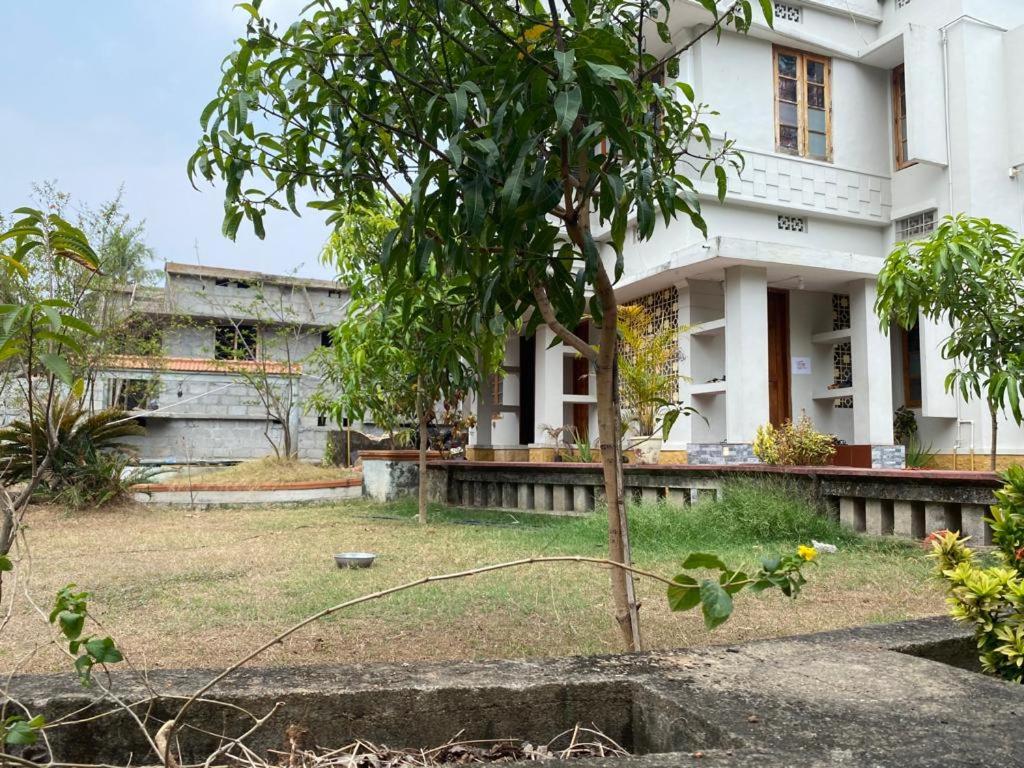 a house with a tree in front of it at ORMAYIDAM RESIDENCY in Trivandrum
