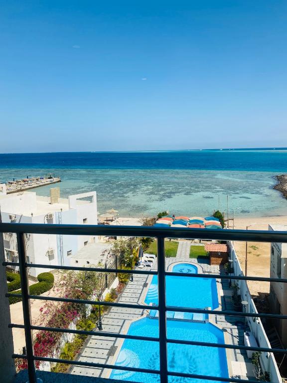 a view of the beach from the balcony of a resort at Tiba Rose hurghada in Hurghada