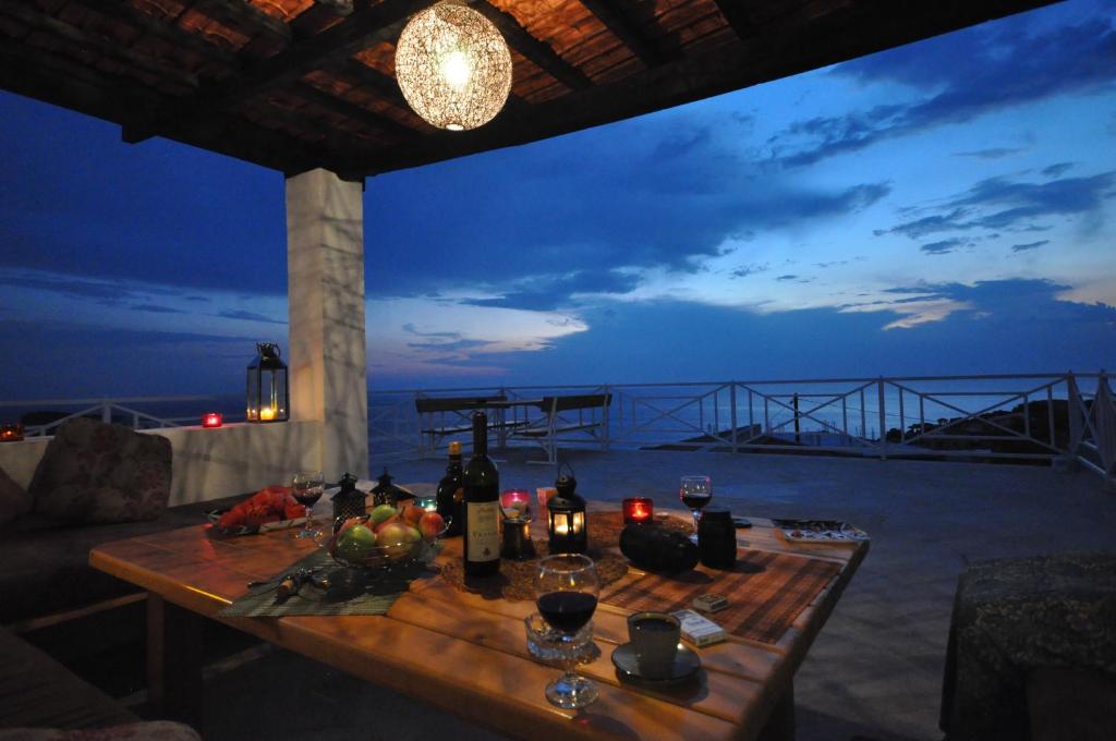 a wooden table with wine bottles and fruit on it at Holidayhome Florecka in Utjeha