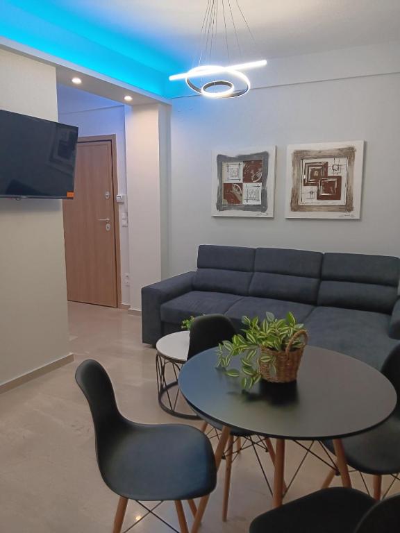 a living room with a couch and a table and chairs at Elena's Place, free parking!!! in Perea
