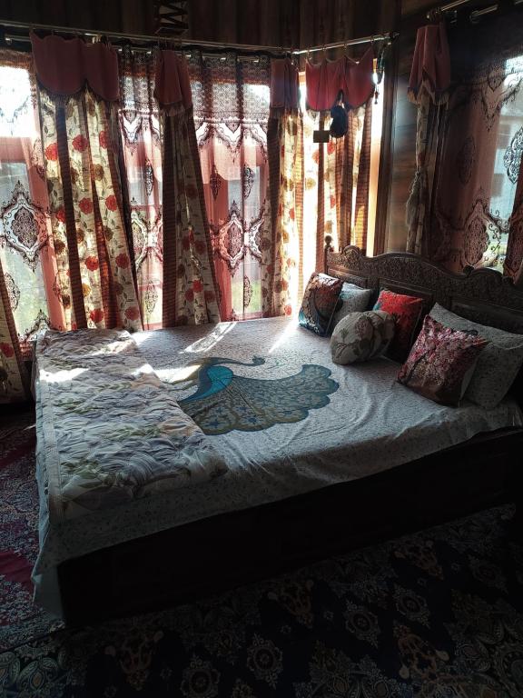 a bed in a bedroom with curtains and pillows at Raj bagh resdidency in Srinagar