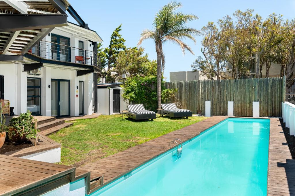 a swimming pool in the backyard of a house at Neighbourgood 1st Crescent Camps Bay in Cape Town