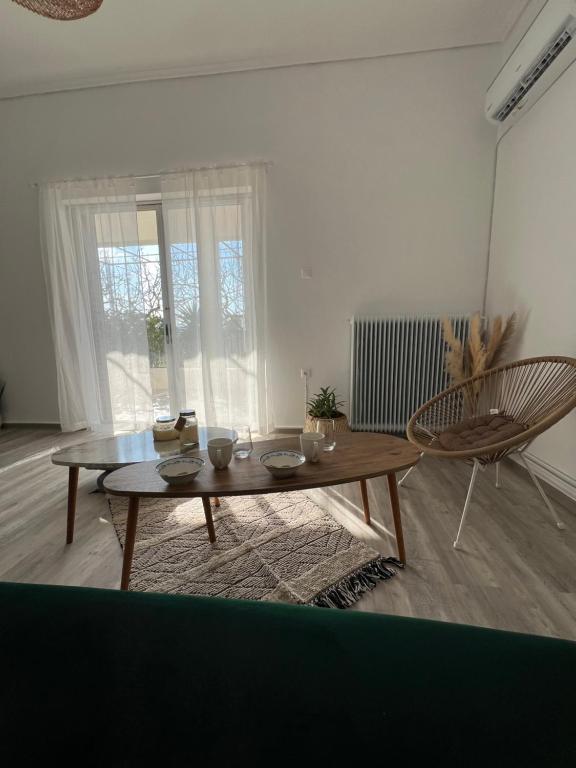 a living room with a table and a chair at Aegina seaview home in Egina