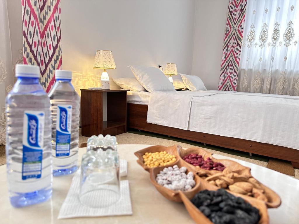 a table with a tray of food and a bottle of water at Gold Khiva in Khiva