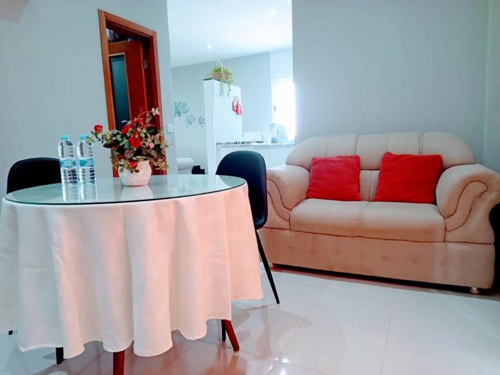 a living room with a table and a couch at Apartamento T1 in Praia