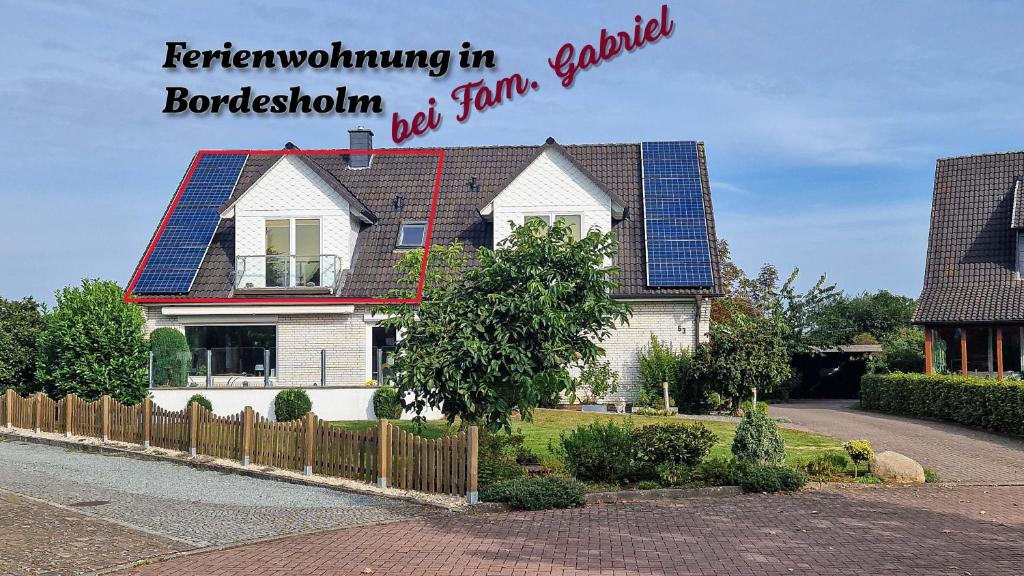 a house with solar panels on the roof at Ferienwohnung-Bordesholm / Inh. Fam. Gabriel in Bordesholm